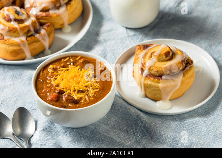 Homemade Chili Soup and Cinnamon Roll for Lunch Stock Photo