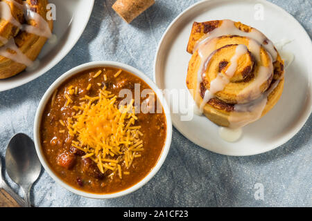 Homemade Chili Soup and Cinnamon Roll for Lunch Stock Photo