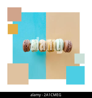 Color matching complementary palette from flat lay image of macarons, flat lay on split light blue and beige paper background Stock Photo