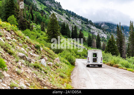 Alta, USA - July 27, 2019: Albion Basin, Utah summer with back of shuttle bus on dirt road in summer in Wasatch mountains Stock Photo