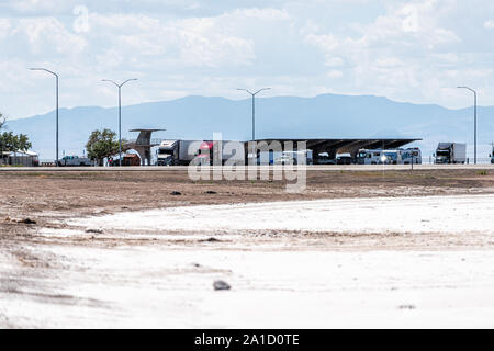 Wendover, USA - July 27, 2019: White Bonneville Salt Flats near Salt Lake City, Utah during day with parking lot rest area Stock Photo