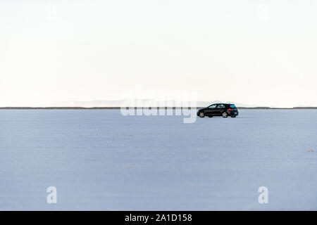 Wendover, USA - July 27, 2019: People driving car on white Bonneville Salt Flats near Salt Lake City, Utah and highway view Stock Photo