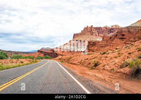 Red rock sandstone formations landscape view from empty road trip in summer in Capitol Reef National Monument in Utah Stock Photo