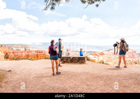 Bryce, USA - August 2, 2019: Many tourists people standing taking pictures at Sunset Point Overlook cliff edge at Bryce Canyon National Park in Utah Stock Photo