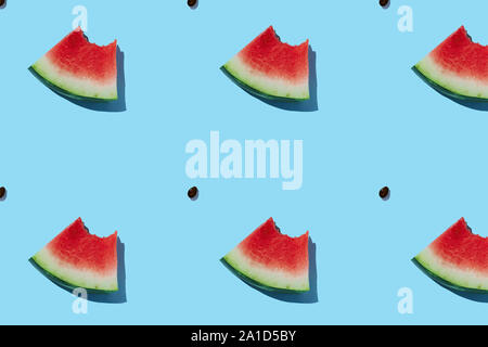 Watermelon pattern made of sliced watermelon on blue background. Stock Photo