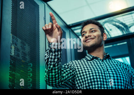 Low angle of a positive nice man being at work Stock Photo