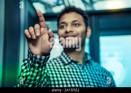 Selective focus of a male hand touching the screen Stock Photo