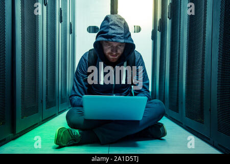 Serious intelligent man sitting on the floor Stock Photo