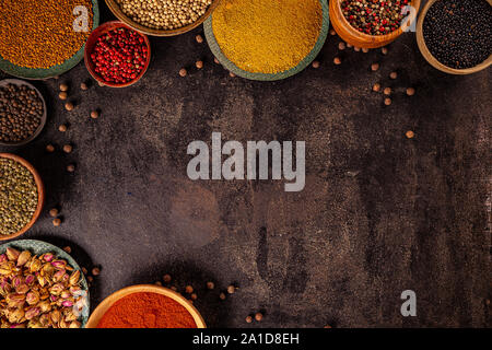 Different kind of spices on a black stone background Stock Photo