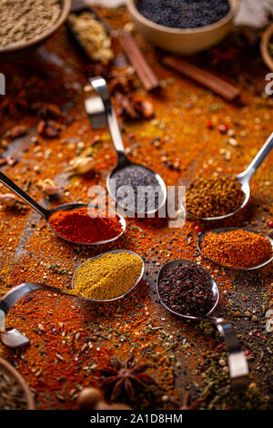 Spices and herbs in metal spoons. Food and cuisine ingredients. Colorful natural additives. Stock Photo