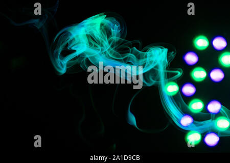 Green smoke and Led light on black background Stock Photo