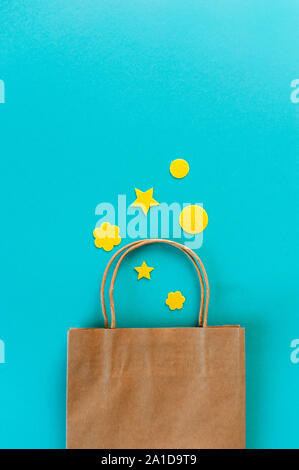 Kraft bag on turquoise background. Eco packaging for shopping. Season of sales and discounts Stock Photo