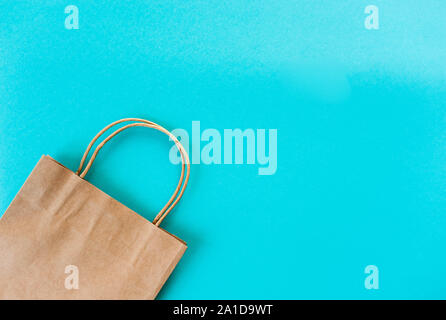 Kraft bag on turquoise background. Eco packaging for shopping. Season of sales and discounts Stock Photo