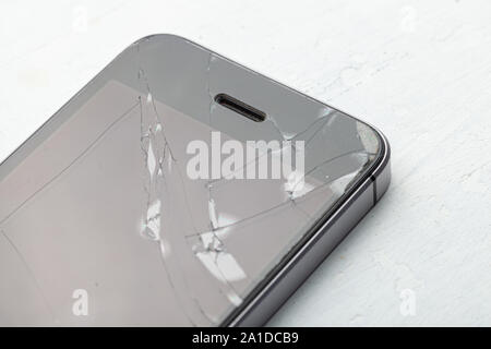 Broken glass phone. Cracks on the display of a mobile phone. Stock Photo