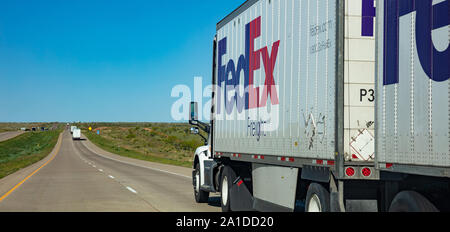 New Mexico highway, US. May 14, 2019: Fedex truck on the highway. Goods transportation and shipping