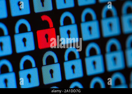 Open padlock as a symbol of the loss of personal information. Hacking or open data. Blue and red pixel locks on a black background, close up. Stock Photo