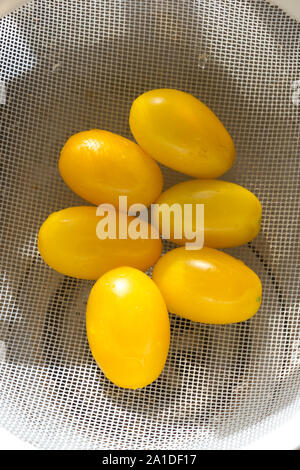 Yellow pear shaped Tomatoes in a drainer Stock Photo
