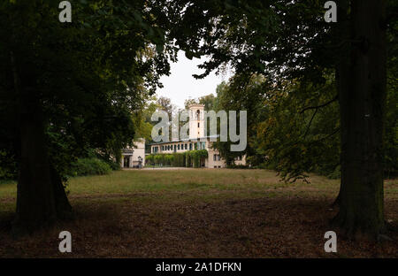 25 September 2019, Berlin: Tower and shed in the landscape park Klein-Glienicke between two trees. The buildings are outbuildings of Glienicke Castle, which is administered by the Prussian Castles and Gardens Foundation, and are located in the Wannsee district. Photo: Soeren Stache/dpa-Zentralbild/ZB Stock Photo