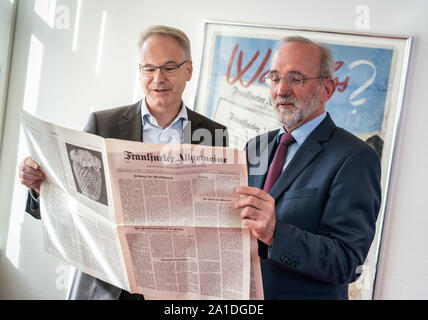 20 September 2019, Hessen: Carsten Knop, Editor-in-Chief of Digitale Produkte (l), and Berthold Kohler, publisher of the Frankfurter Allgemeine Zeitung (FAZ, r), are standing in the editorial offices with a copy of the first FAZ issue from 01.11.1949. The newspaper celebrates its 70th anniversary. Photo: Frank Rumpenhorst/dpa Stock Photo