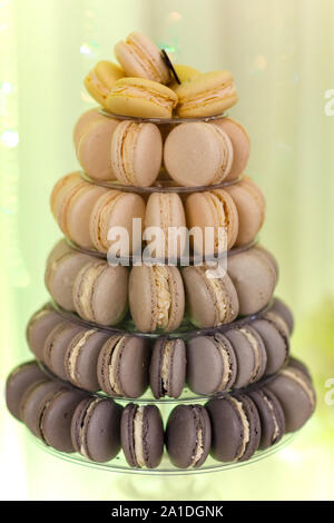 Luxury wedding candy bar table set. Macaron tower or pyramid and cupcakes on sweet dessert table. Pastel stylish colours. sweets, treats Stock Photo