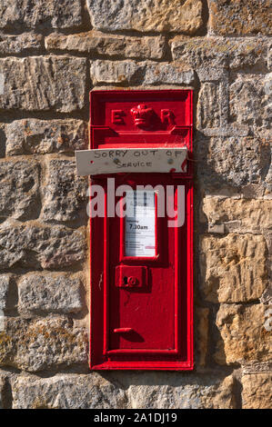 A post box with 'Sorry out of service' notice, on the side of a barn in Lower Lemington, Gloucestershire, England, UK Stock Photo