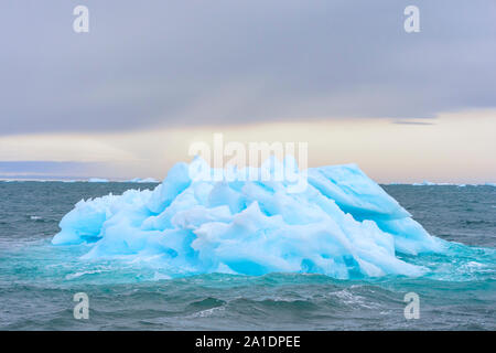 Blue Iceberg drifting in Hinlopen Strait, Spitsbergen Island, Svalbard archipelago, Norway Stock Photo