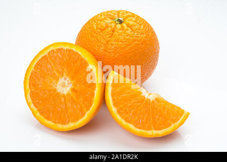 closeup of two oranges isolated on white background, one buy and one slice Stock Photo