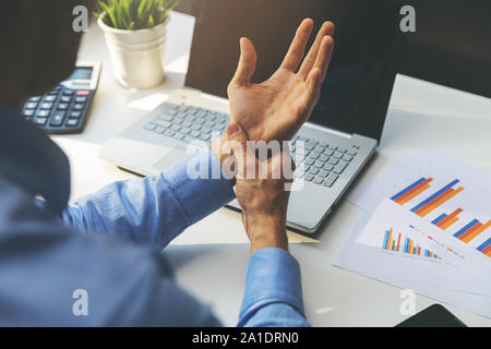 office syndrome - man suffering from wrist joint pain Stock Photo