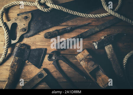 old rusty hand tools on wooden plank background. top view Stock Photo