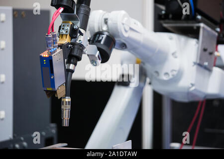 Automatic welding robot in a modern factory in operation. Stock Photo