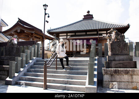 TOKYO, JAPAN - MARCH 31 : Travelers thai women posing portrait for take photo with Small shrine in Naritasan Omote Sando or Narita old town at Chiba P Stock Photo