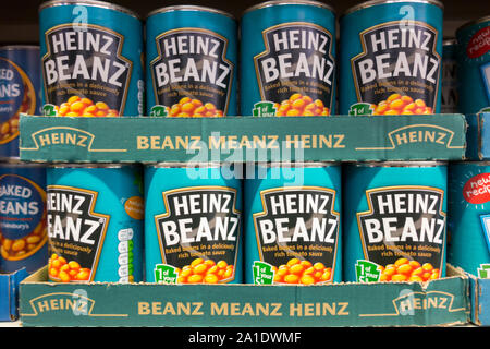 Tins of Heinz Baked Beans on a supermarket shelf in London, UK