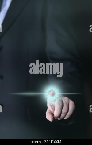Businessman uses Touchscreen with his finger, glowing icon Stock Photo