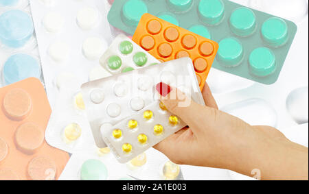 The pills in the hands of doctors against the background of different tablets to treat diseases Stock Photo