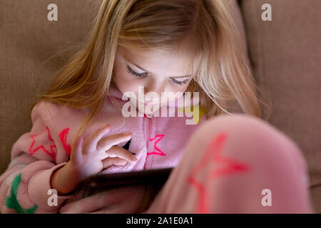 Girl using tablet at home Stock Photo