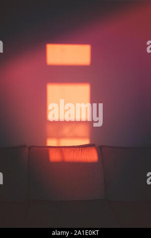 Abstract shadow silhouette of window frame from sun beam on wall in room Stock Photo