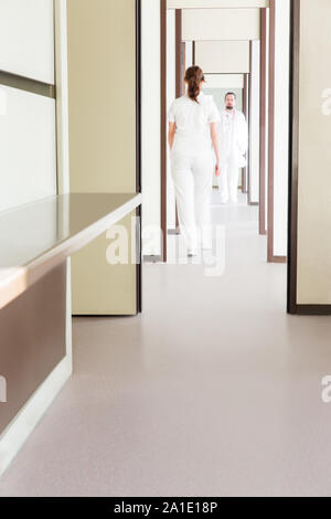 medicine staff in corridor is walking while working Stock Photo