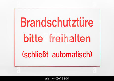 sign with red coloured letters on a white door, with german words which means fire emergency door Stock Photo