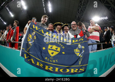 Worcester Warriors and England fans show support in the stands with a flag during the 2019 Rugby World Cup match at the Kobe Misaki Stadium, Japan. Stock Photo