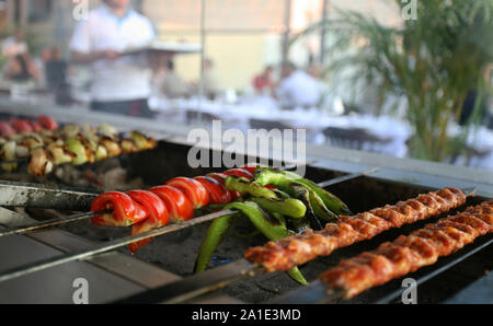 Turkish Kebabs (Adana Kebab) on the barbecue grill at the restaurant Stock Photo