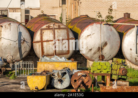 Territory of abandoned industrial area waiting for cleaning. Junk at former factory. Stock Photo