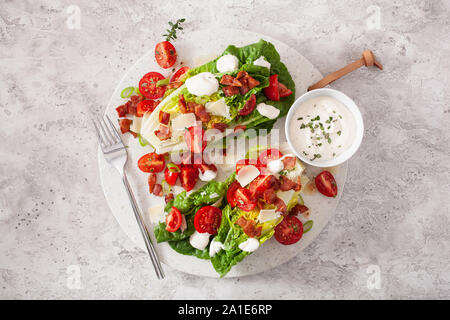 romaine lettuce topped with bacon tomato parmesan, sauce. healthy keto paleo diet lunch Stock Photo