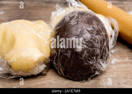 Two dough balls with clingfilm or plastic wrap, concept dough relaxation and dough rest Stock Photo