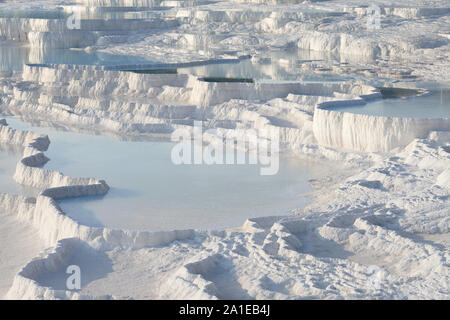 Pamukkale white travertine terraces and thermal pools in sunset, Turkey Stock Photo
