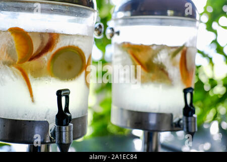 orange lemon apple fruit slices floating in water. refreshing citrus drink Stock Photo