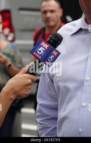 New York, USA. 11th Sep, 2019. One hand holds a microphone with the logo of the TV channel Fox 5 News. Fox 5 News is part of WNYW Channel 5, an American television channel based in New York. WNYW belongs to the FOX network. Credit: Alexandra Schuler/dpa/Alamy Live News Stock Photo