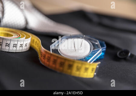 Jacket and tie detail with tailor meter and pins. Concept of Italian tailoring. Quality, style, made in Italy. Stock Photo