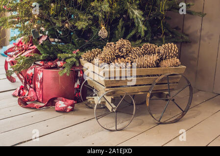 Various Christmas presents under the illuminated Christmas tree. Stock Photo