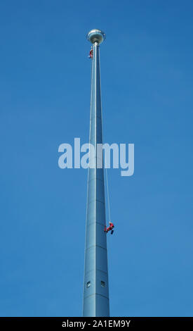 Dangerous Occupation - Cleaners at work at the top of one of the two Petronas Towers in Kuala Lumpur Stock Photo