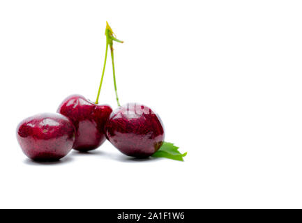 Red cherry with stalk and leaf isolated on white background. Ripe red sweet cherry. Sweet and juicy organic cherry. Fresh fruit for summer dessert. Stock Photo
